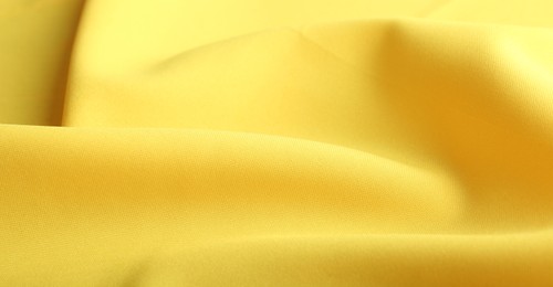 Photo of Texture of beautiful yellow fabric as background, closeup