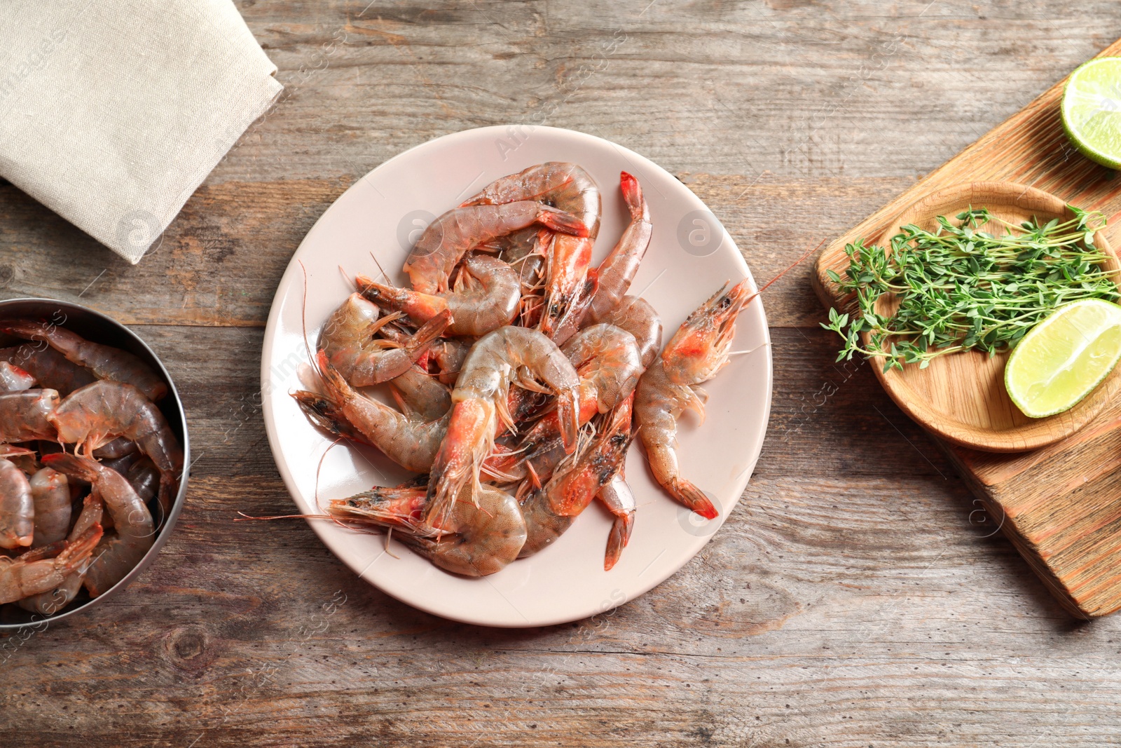 Photo of Plate with shrimps on wooden table