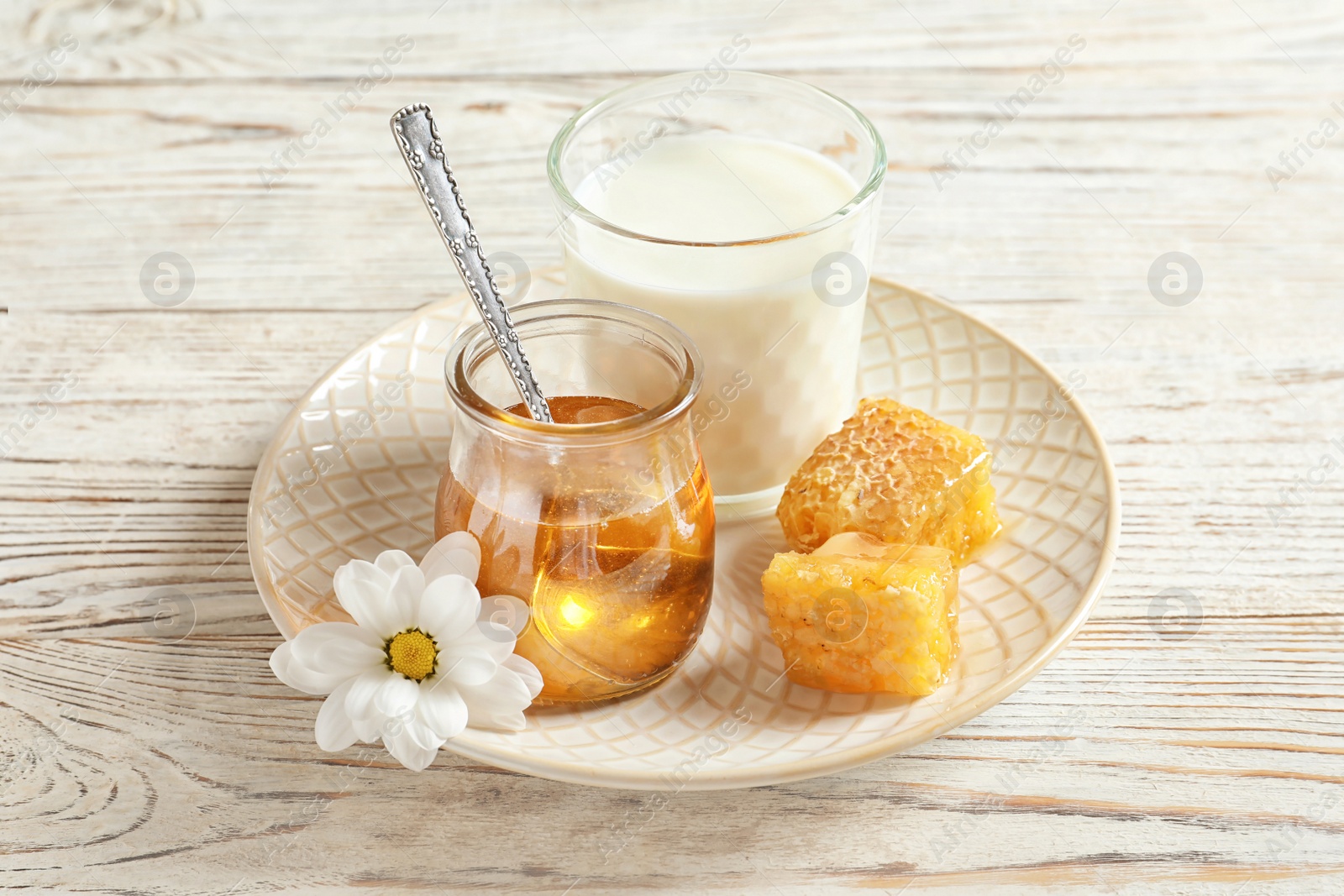 Photo of Beautiful composition with milk and honey on wooden background