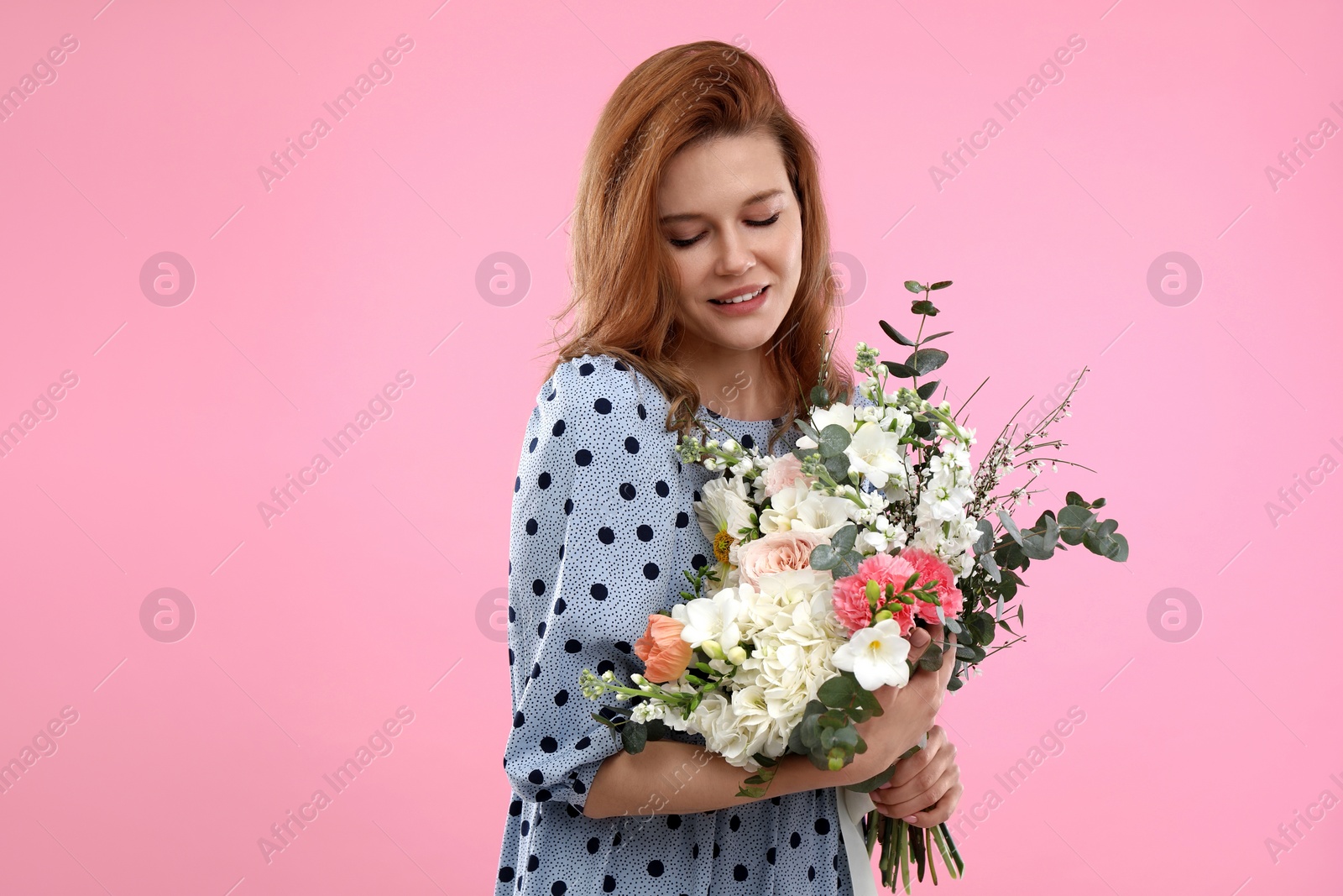 Photo of Beautiful woman with bouquet of flowers on pink background