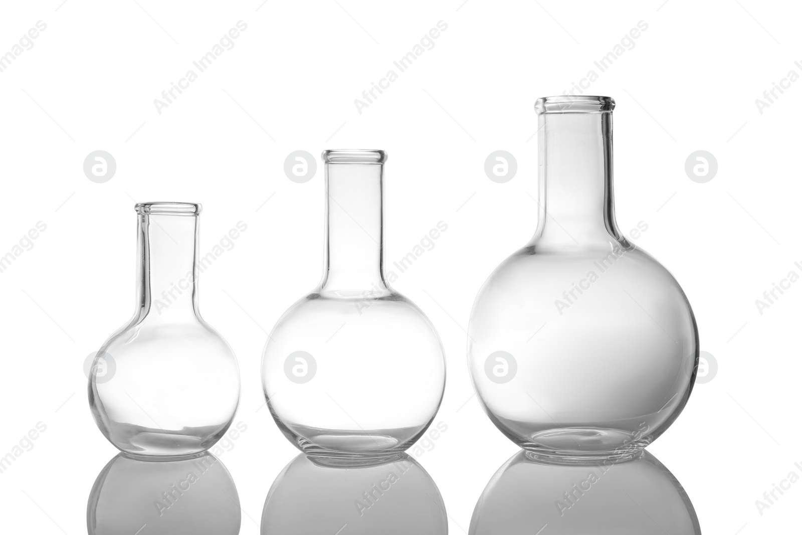 Photo of Empty Florence flasks on white background. Laboratory glassware