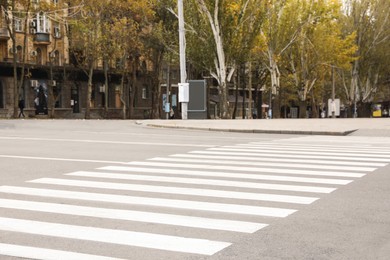 White pedestrian crossing on empty city street