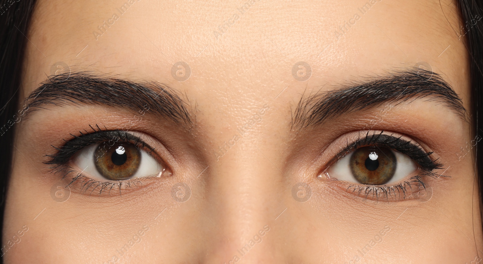 Photo of Young woman with permanent eyeliner makeup, closeup