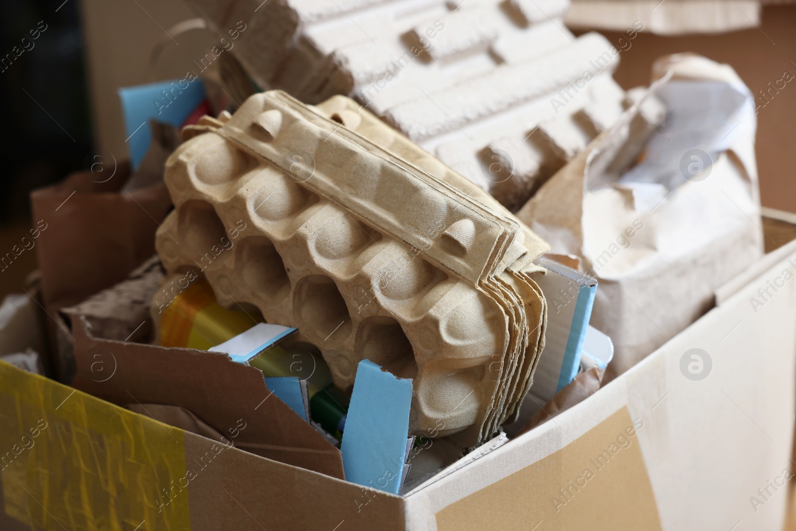 Photo of Reuse concept. Different trash in cardboard box for recycling, closeup