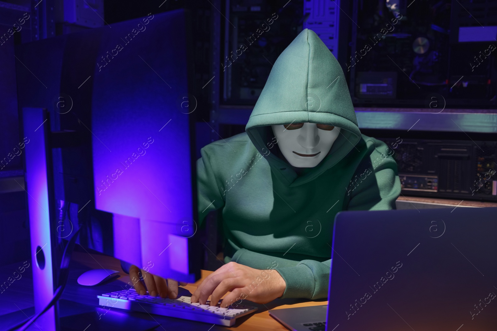 Photo of Hacker working with computers in dark room. Cyber attack