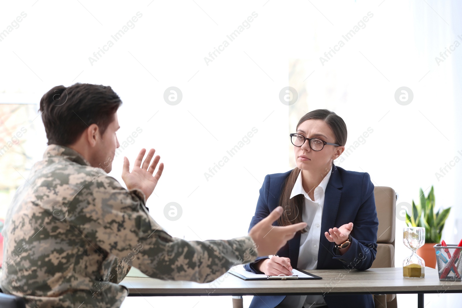 Photo of Psychotherapist working with male military officer in office