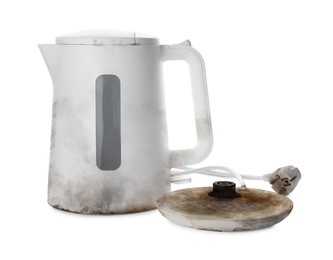 Image of Burnt electric kettle with base and plug on white background