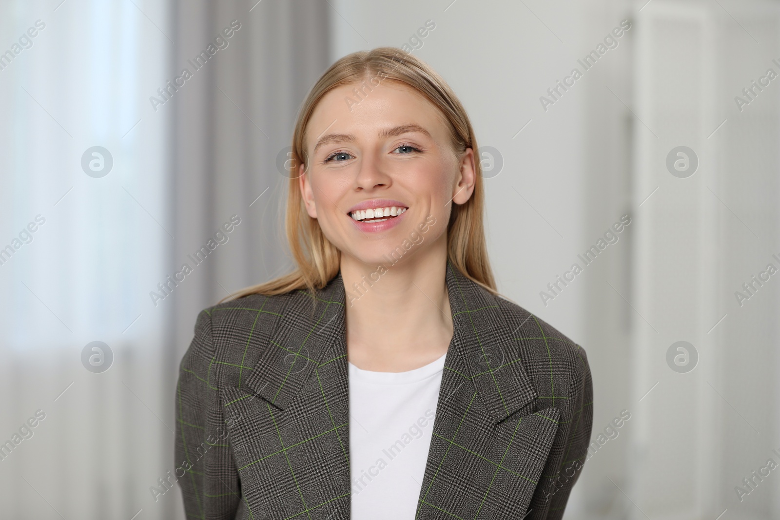 Photo of Portrait of beautiful young woman in stylish jacket indoors