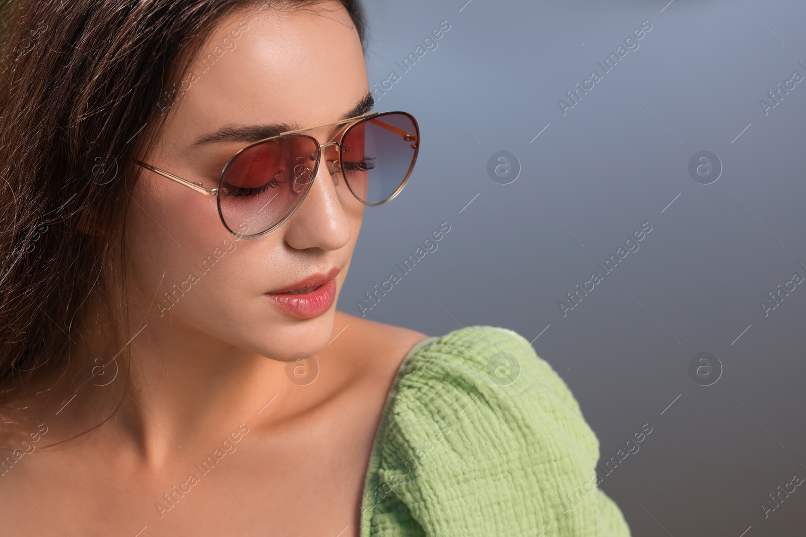 Photo of Beautiful woman in sunglasses outdoors, space for text