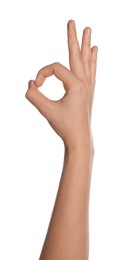 Woman showing okay gesture on white background, closeup of hand