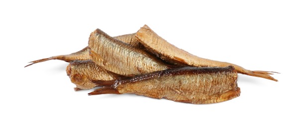 Photo of Many tasty smoked sprats isolated on white