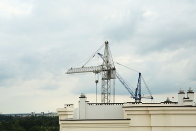 Construction site with tower cranes near building