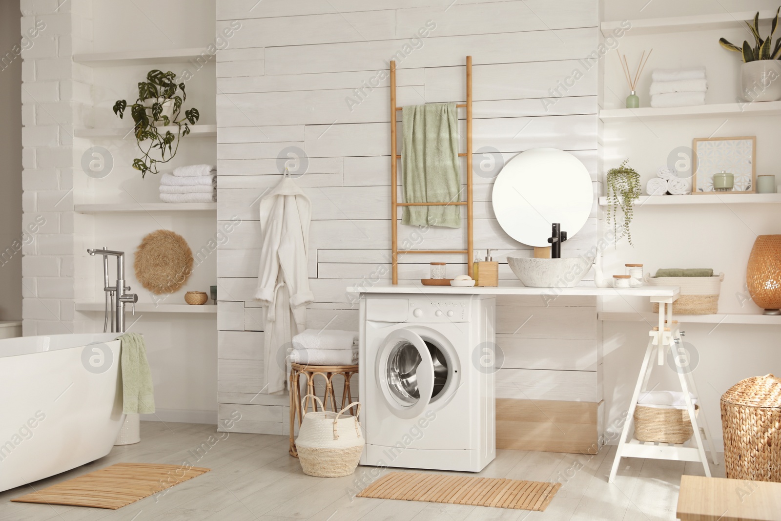 Photo of Stylish bathroom interior with modern washing machine