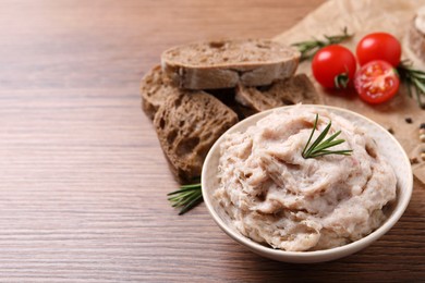 Delicious lard spread in bowl on wooden table. Space for text