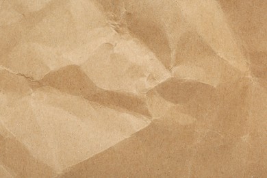 Crumpled kraft notebook sheet as background, top view