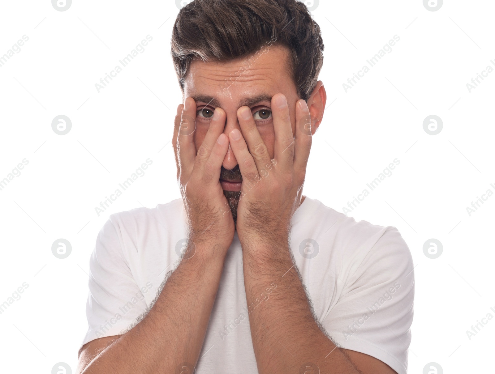 Photo of Embarrassed man covering face with hands on white background