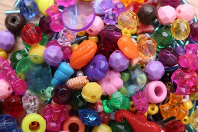 Photo of Many different bright beads as background, top view