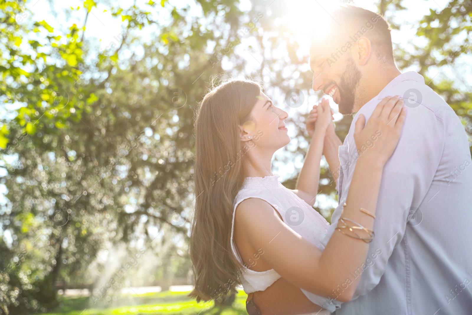 Photo of Lovely young couple dancing together in park on sunny day