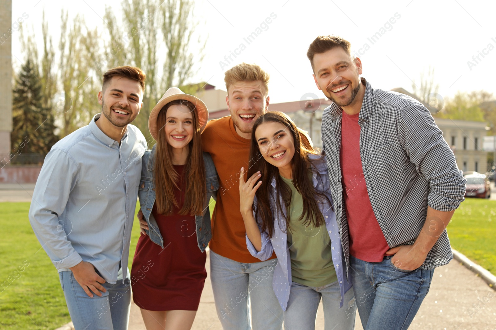 Photo of Happy people walking outdoors on sunny day