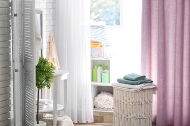 Photo of Modern bathroom interior with laundry basket