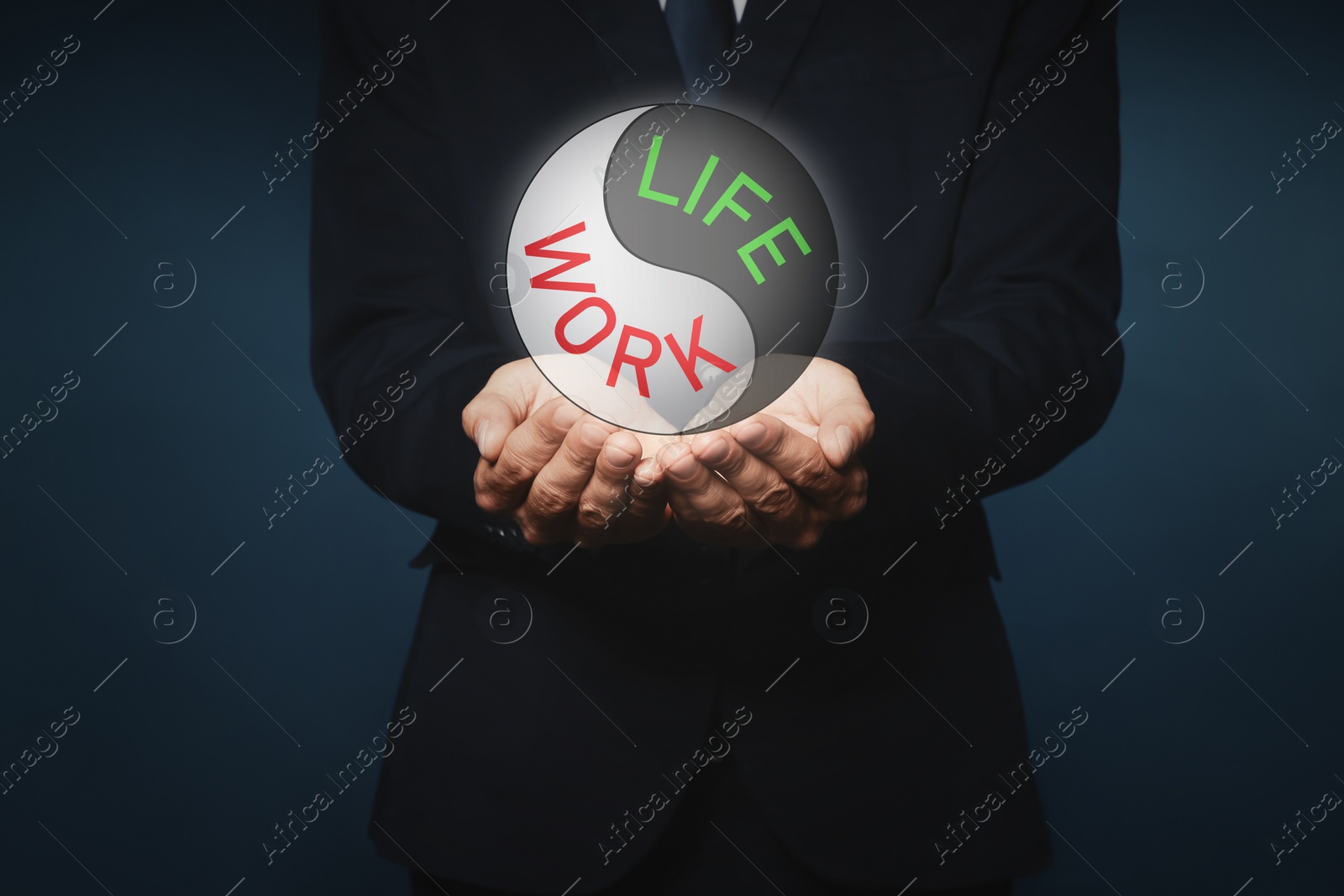 Image of Businessman showing balance between life and work on dark background, closeup