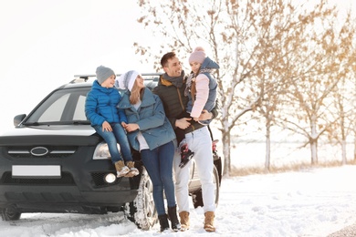 Photo of Happy family near car on winter day