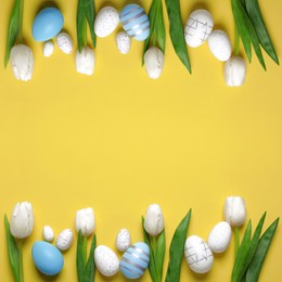 Image of Flat lay composition with decorated Easter eggs and flowers on yellow background. Space for text