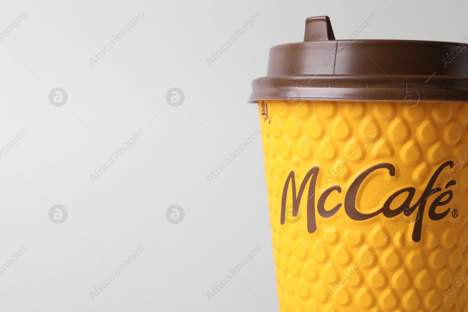 Photo of MYKOLAIV, UKRAINE - AUGUST 12, 2021: Hot McDonald's drink on light background, closeup. Space for text