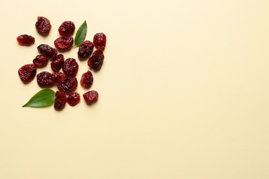 Photo of Cranberries on color background, top view with space for text. Dried fruit as healthy snack