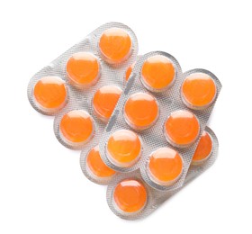 Photo of Blisters with orange cough drops on white background, top view