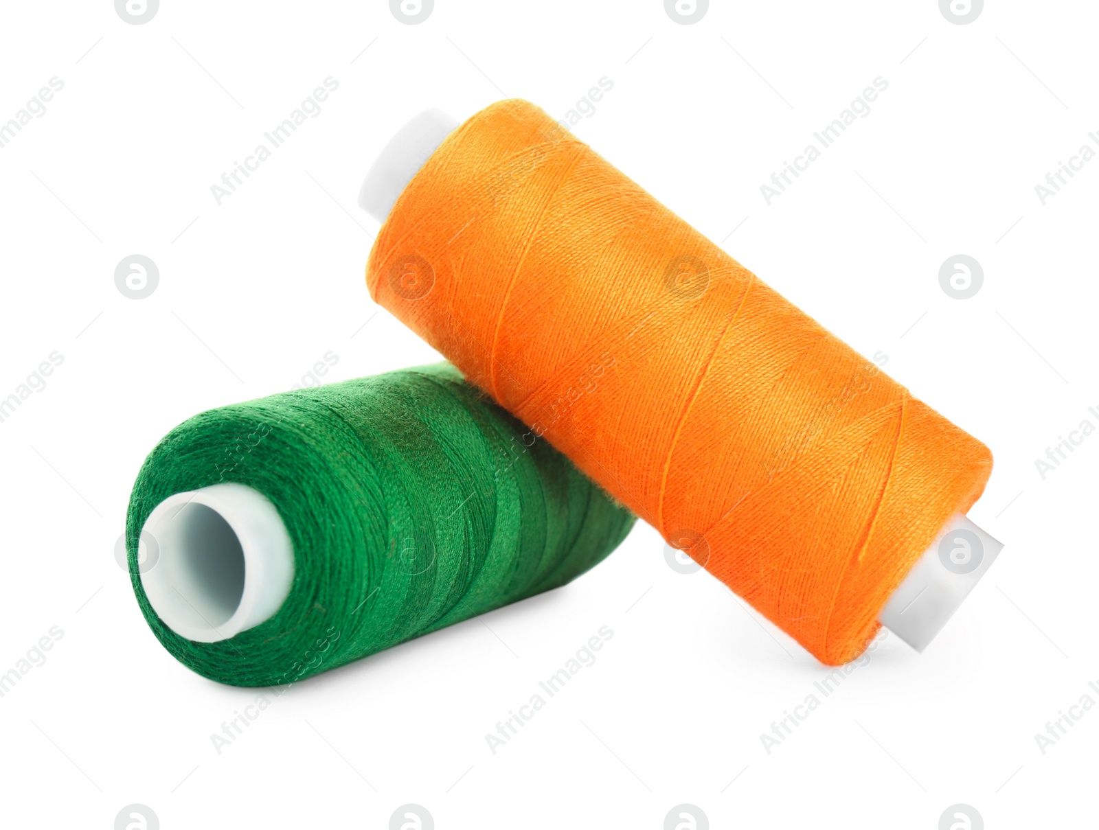 Photo of Different colorful sewing threads on white background