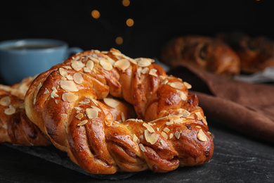 Fresh delicious pastries on black table, closeup