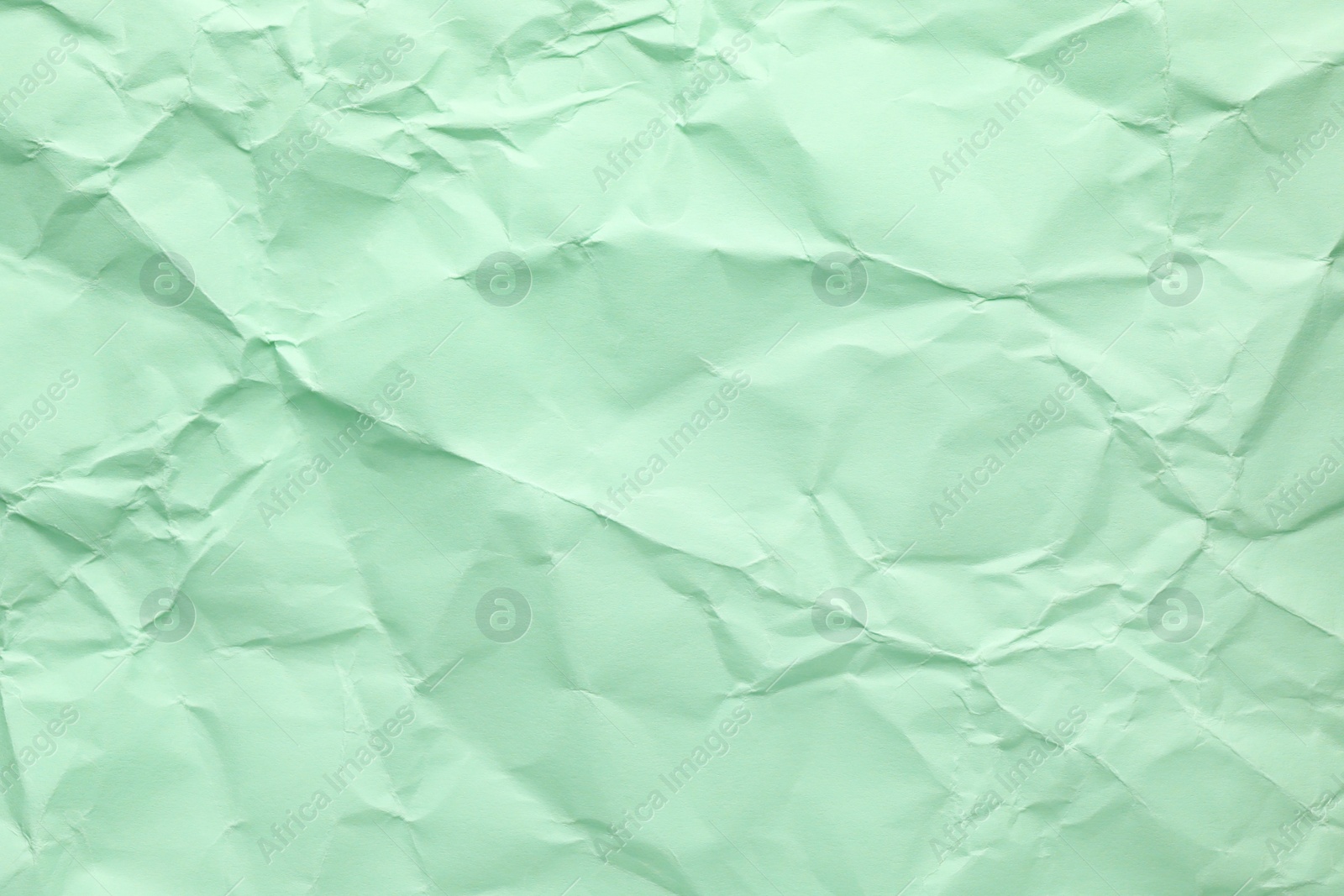 Photo of Sheet of color crumpled paper as background. Space for design