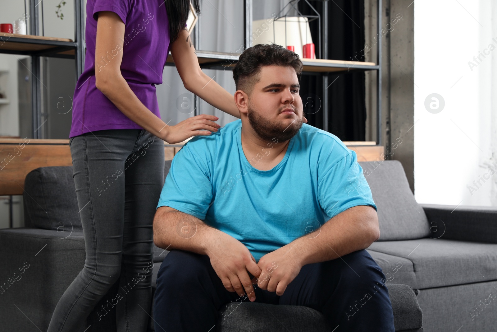 Photo of Woman comforting her depressed overweight friend at home
