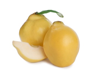 Photo of Whole and cut delicious quinces on white background