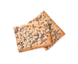 Photo of Cereal crackers with flax, sunflower and sesame seeds isolated on white, top view