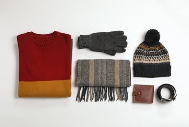 Flat lay composition with male winter clothes on white background