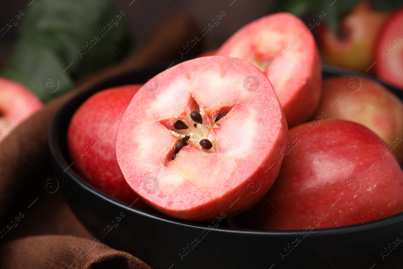 Photo of Tasty apples with red pulp on table, closeup