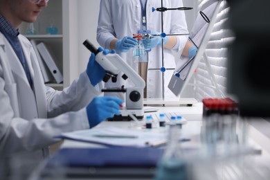 Photo of Scientists working with samples in laboratory, closeup. Medical research