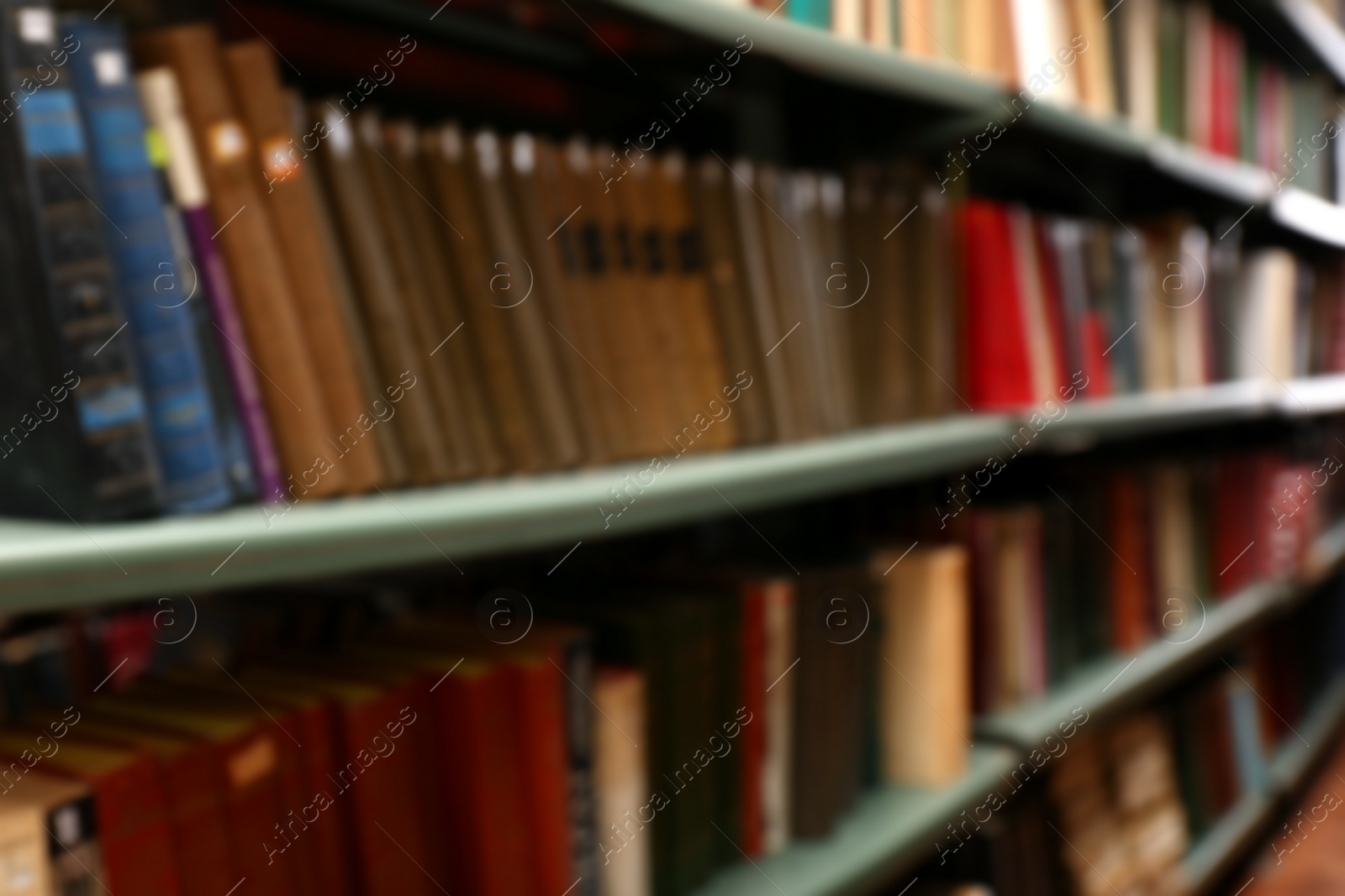 Photo of Blurred view of books on shelves in library