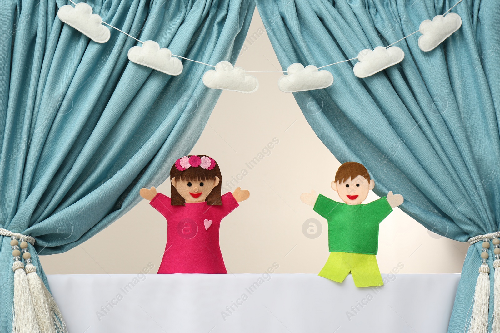 Photo of Creative puppet show on white stage indoors