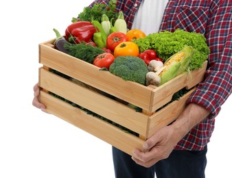 Harvesting season. Farmer holding wooden crate with vegetables on white background, closeup