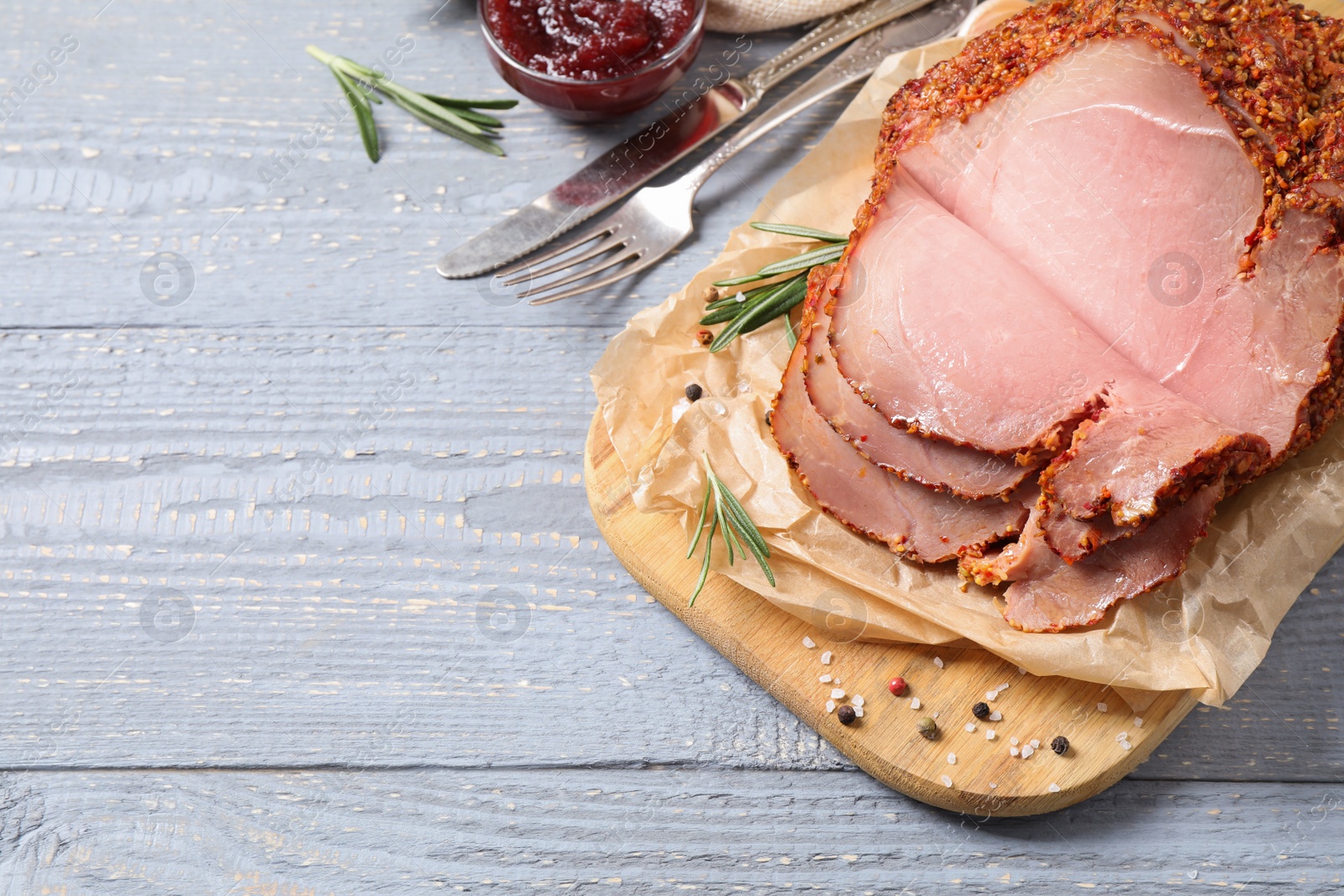 Photo of Delicious ham served on grey wooden table, above view. Space for text