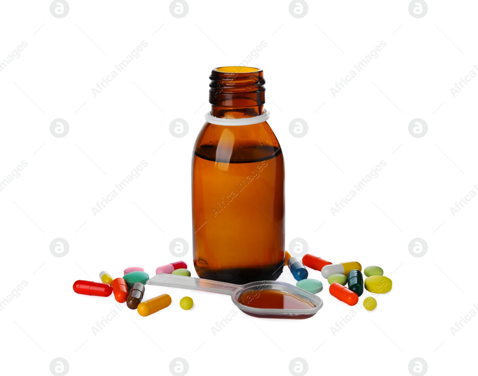 Photo of Pills, bottle with plastic spoon of syrup on white background. Cough and cold medicine