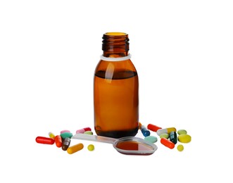 Photo of Pills, bottle with plastic spoon of syrup on white background. Cough and cold medicine