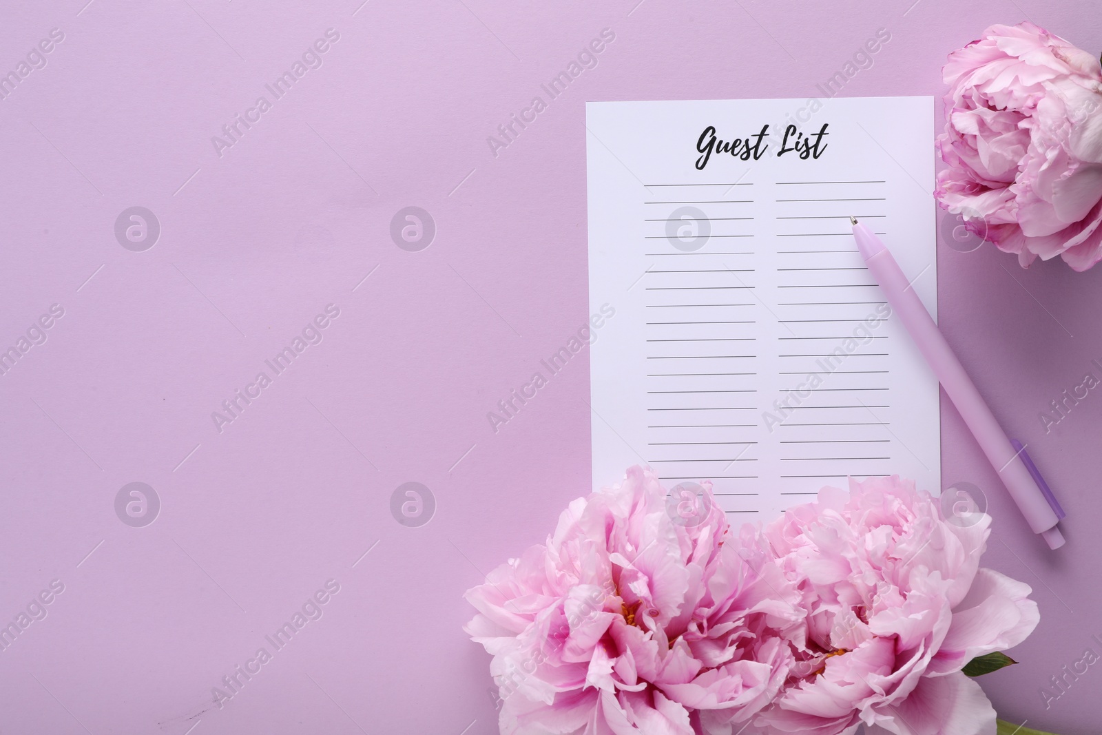 Photo of Guest list, pen and beautiful flowers on violet background, flat lay. Space for text