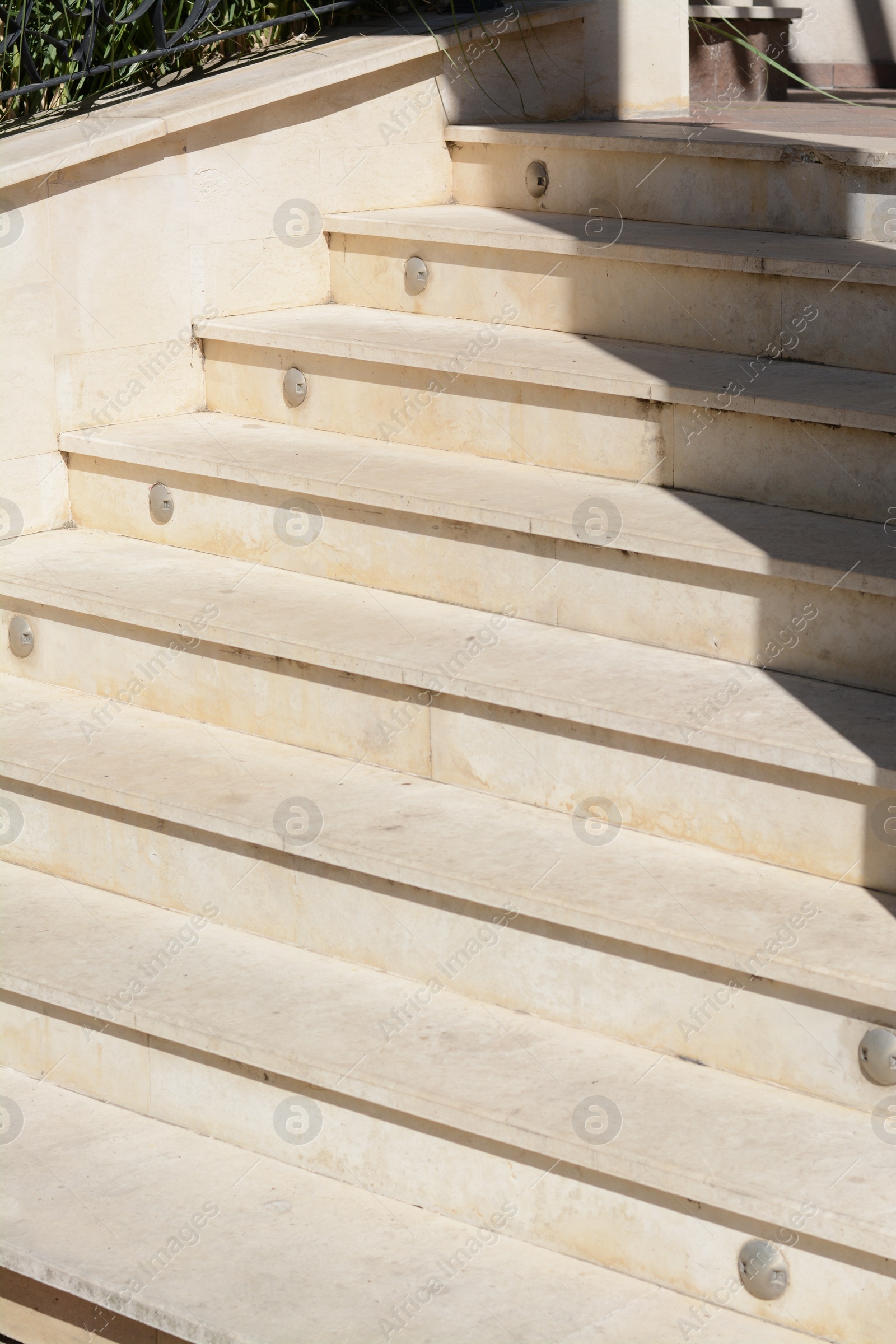 Photo of Staircase covered with tiles outdoors on sunny day, closeup