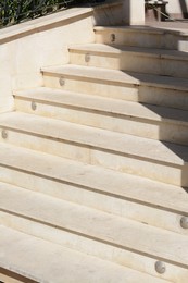 Photo of Staircase covered with tiles outdoors on sunny day, closeup