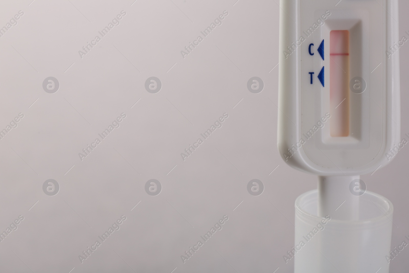 Photo of Disposable express test on light grey background, closeup. Space for text