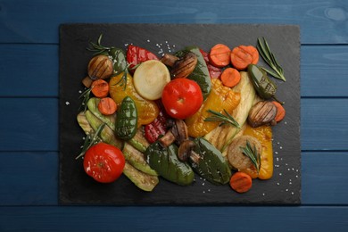 Photo of Delicious grilled vegetables on blue wooden table, top view